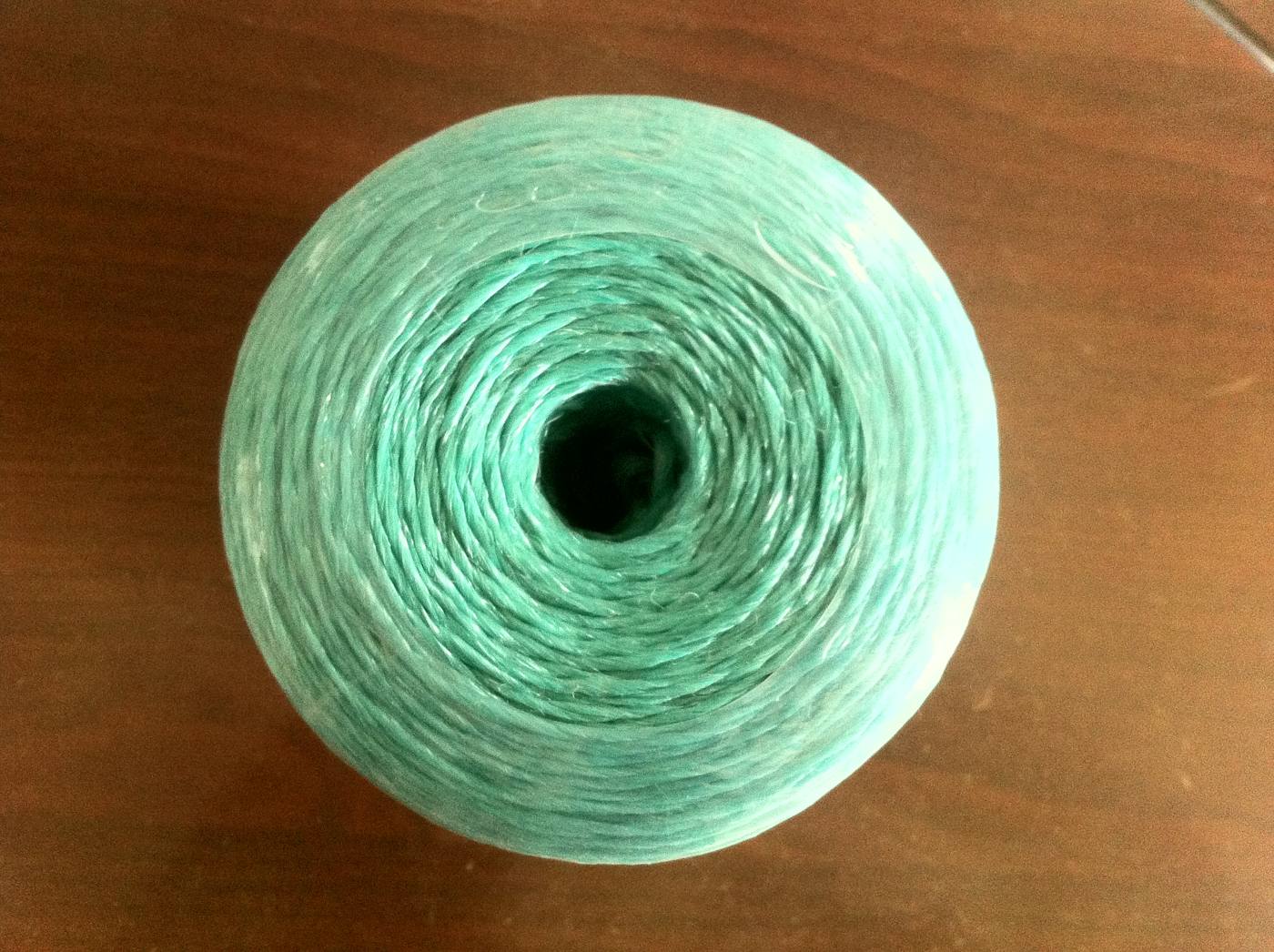Green multifilament polyethylene twine on a small spool