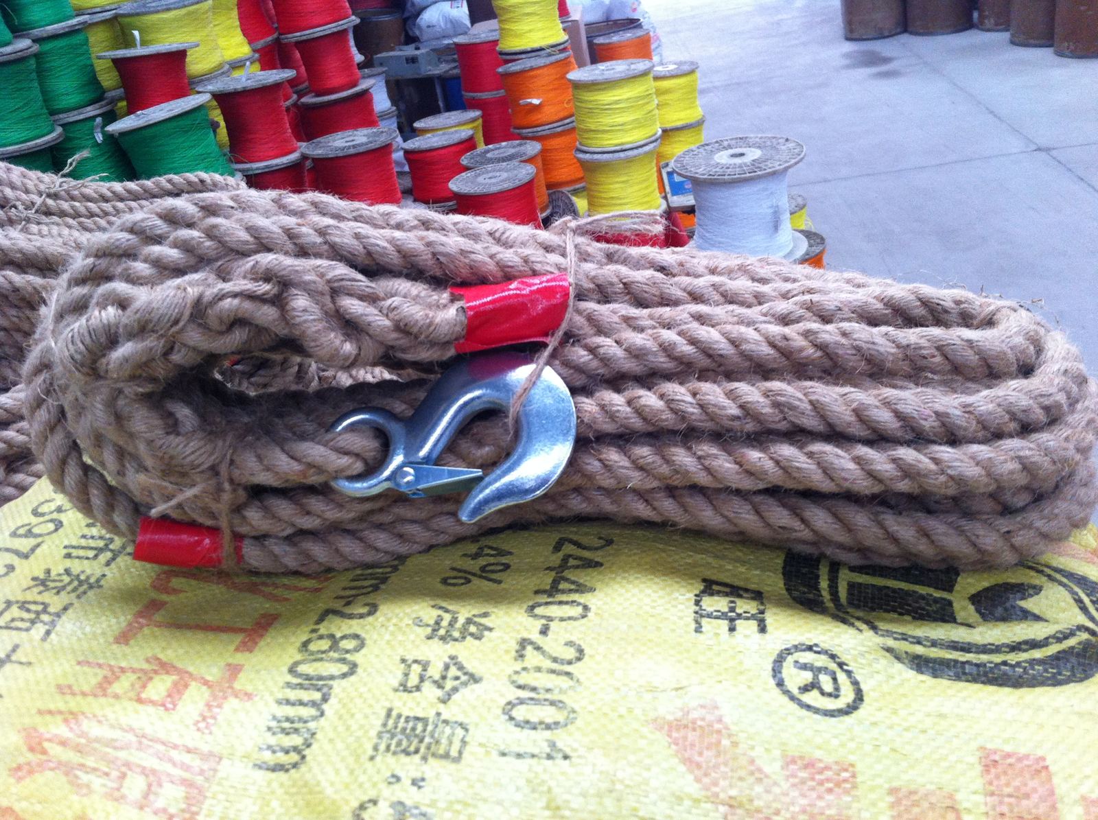 Natural jute twisted rope bundled with a metal hook accessory