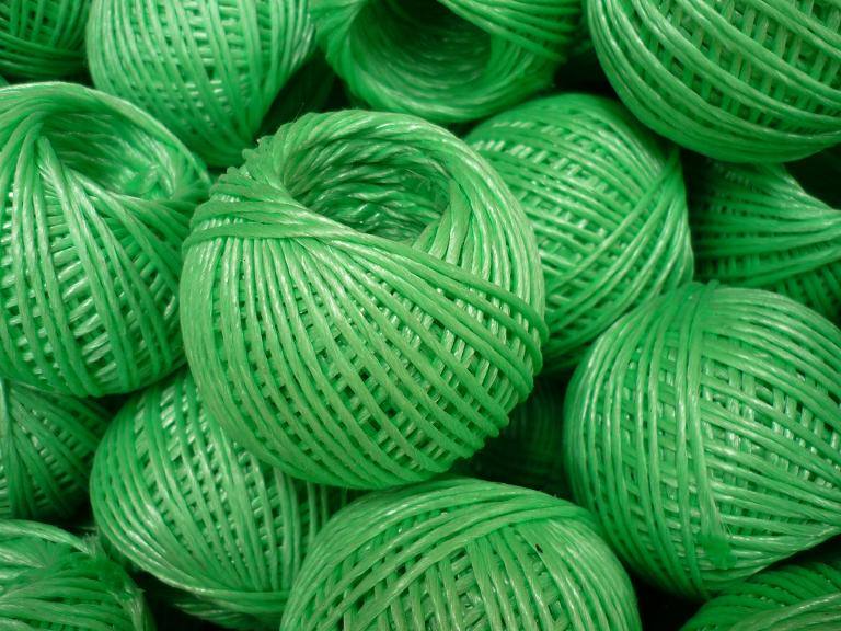 Pile of green garden tying twine balls for crop support