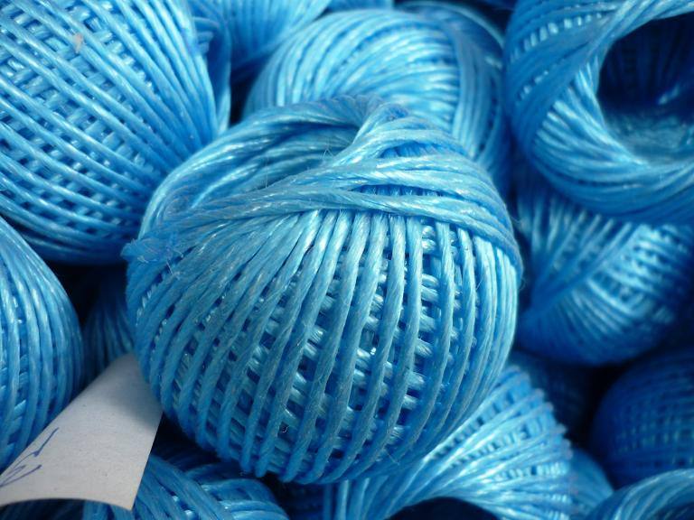 Blue hollow-braided polypropylene rope skein ball, side view