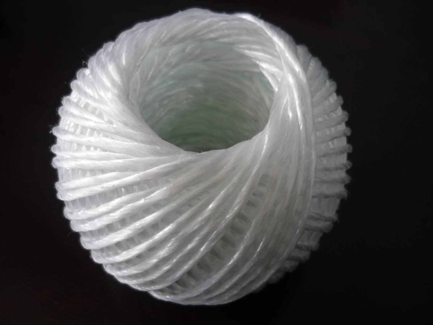 White polyethylene hollow-braid garden / clothesline on a dark background
