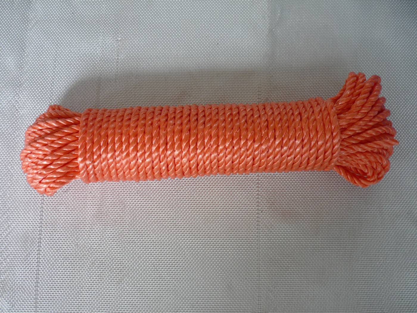 Orange 3-strand twisted polypropylene rope on a small plastic spool